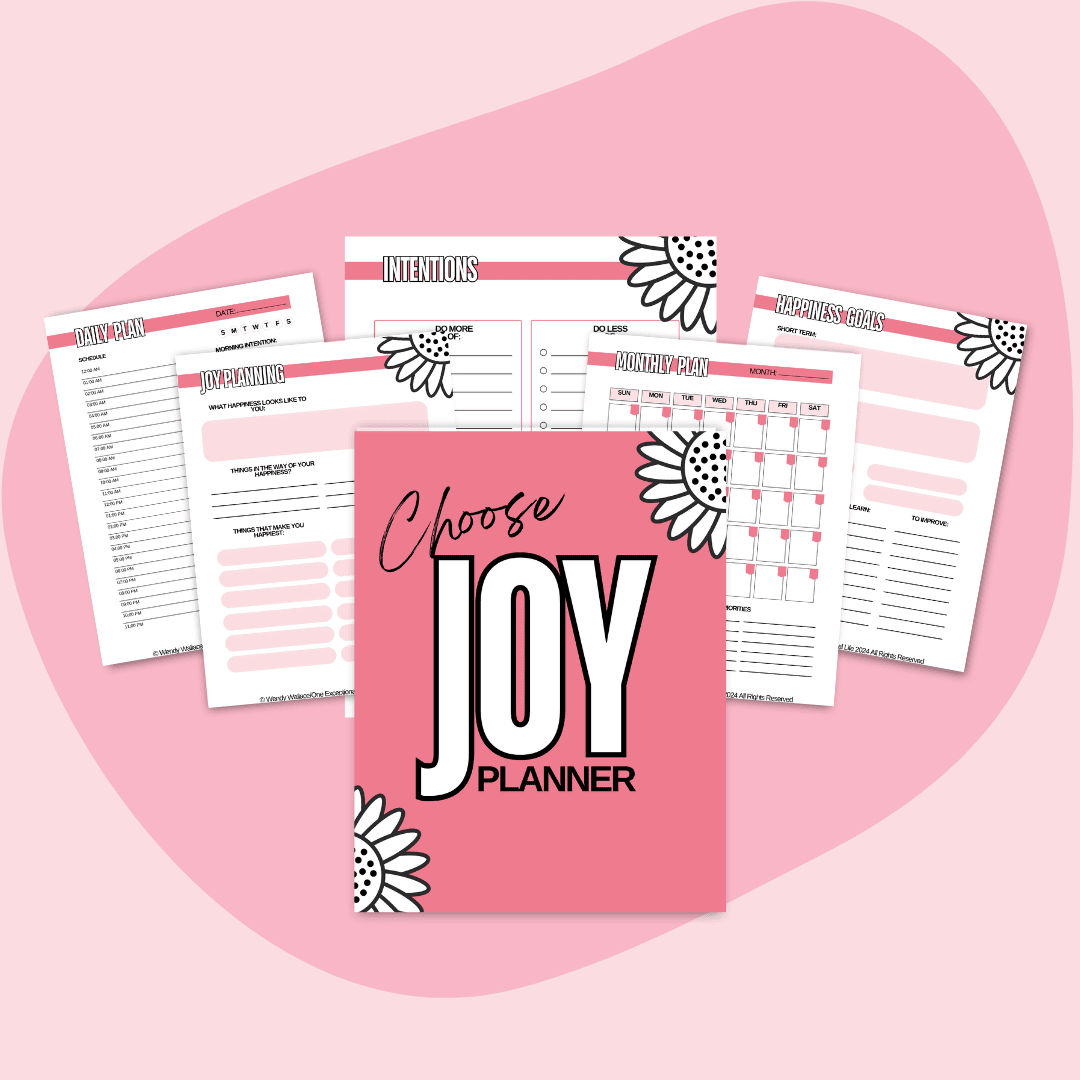 This is a mockup of Choose Joy Workbook in the center. Surrounding the cover are several open pages from the workbook. The workbook cover and pages are decorated with floral designs, and the background is a soft pink abstract shape on a lighter pink base.