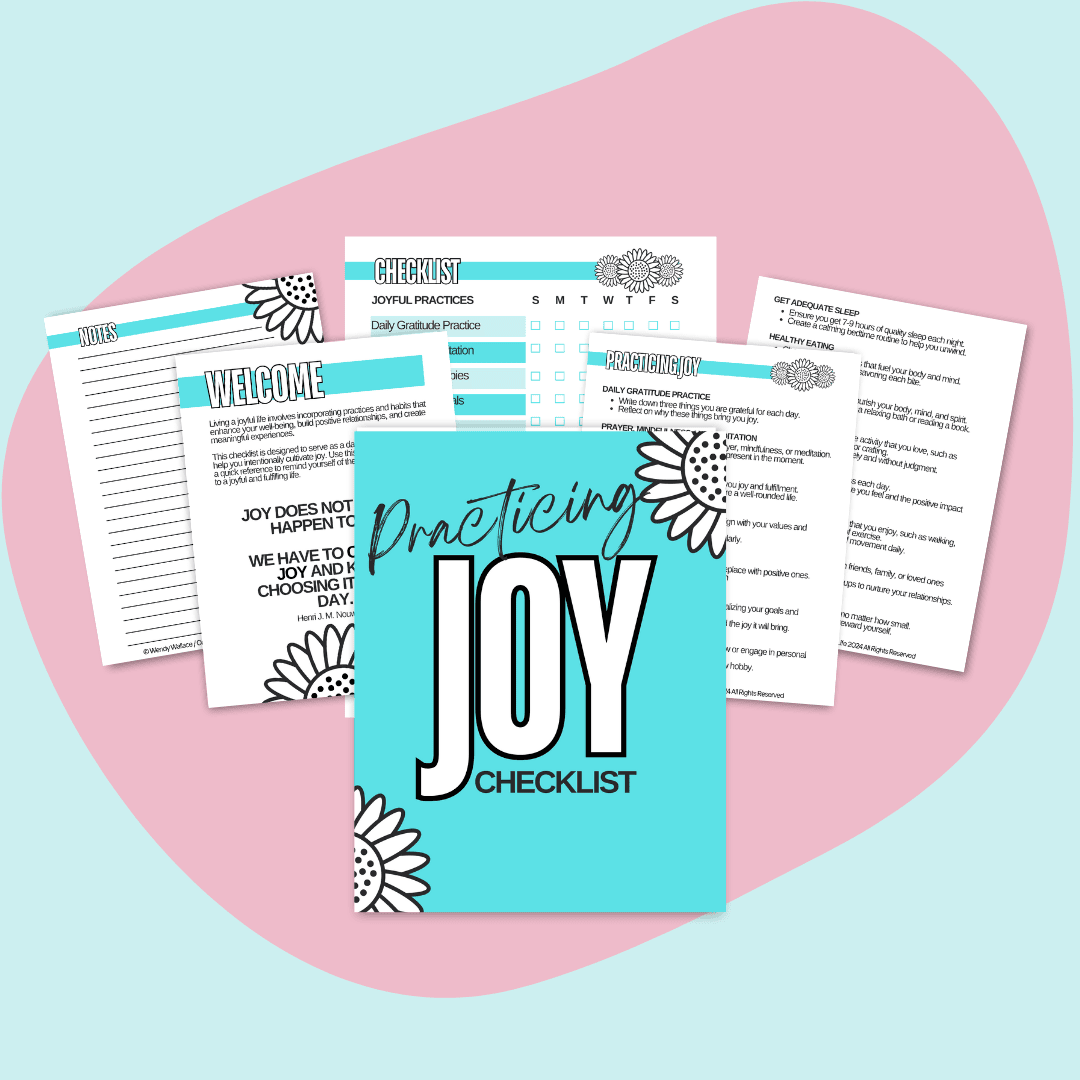 This is a mockup of Practicing Joy Checklist in the center. Surrounding the cover are several open pages from the workbook. The workbook cover and pages are decorated with floral designs, and the background is a soft pink abstract shape on a lighter pink base.